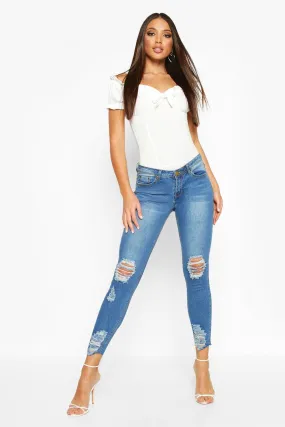 Mid Rise Distressed Knee And Ankle Skinny Jeans